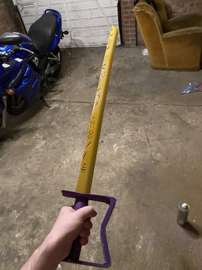 Image of unpainted purple handle and primed yellow blade being held.