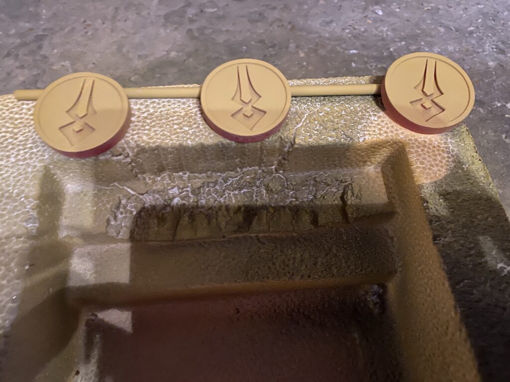 Three coins with a light layer of Filler Primer.