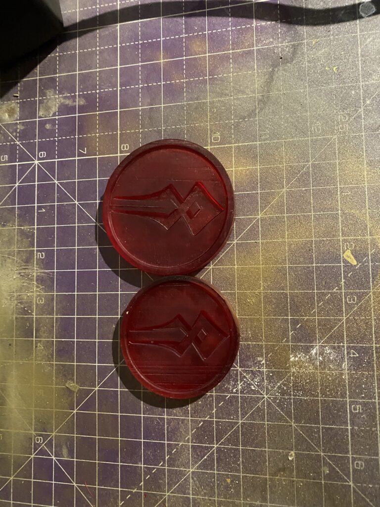 60mm and 70mm Charons Obol coin next to each other, fresh from printing.