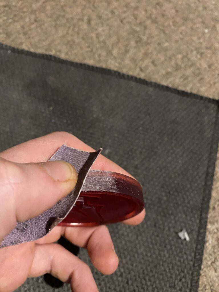 The edges of the coins being lightly sanded.