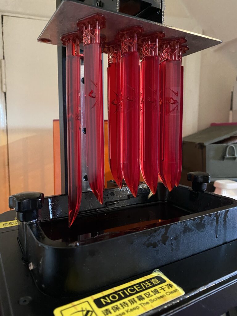 The spikes being printed on a resin printer.