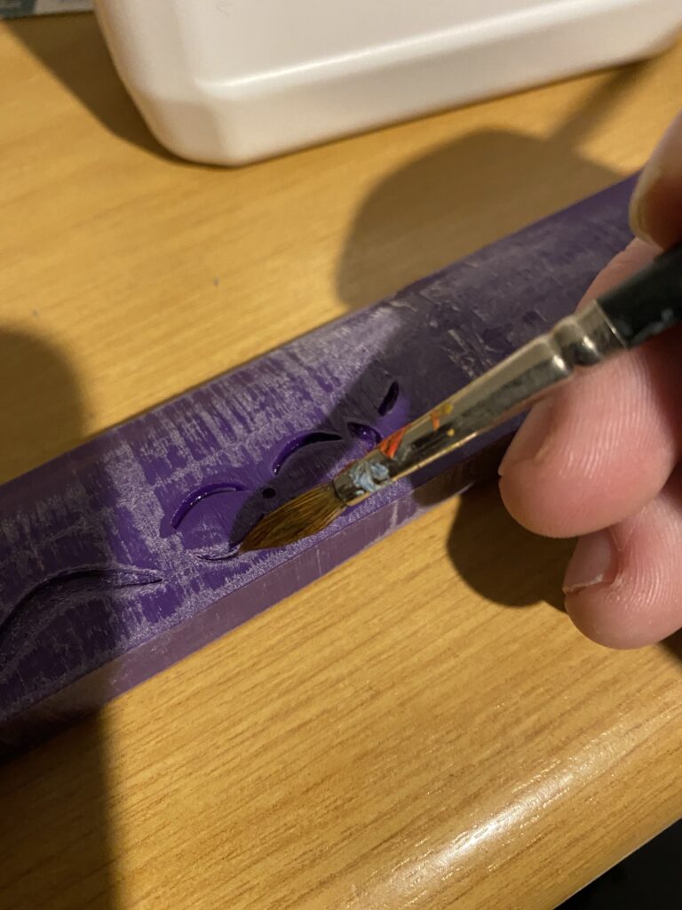 Acetone being applied to the engravings with a paintbrush.