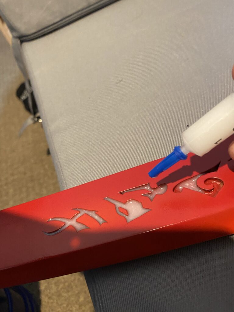 White resin being applied to the runes.