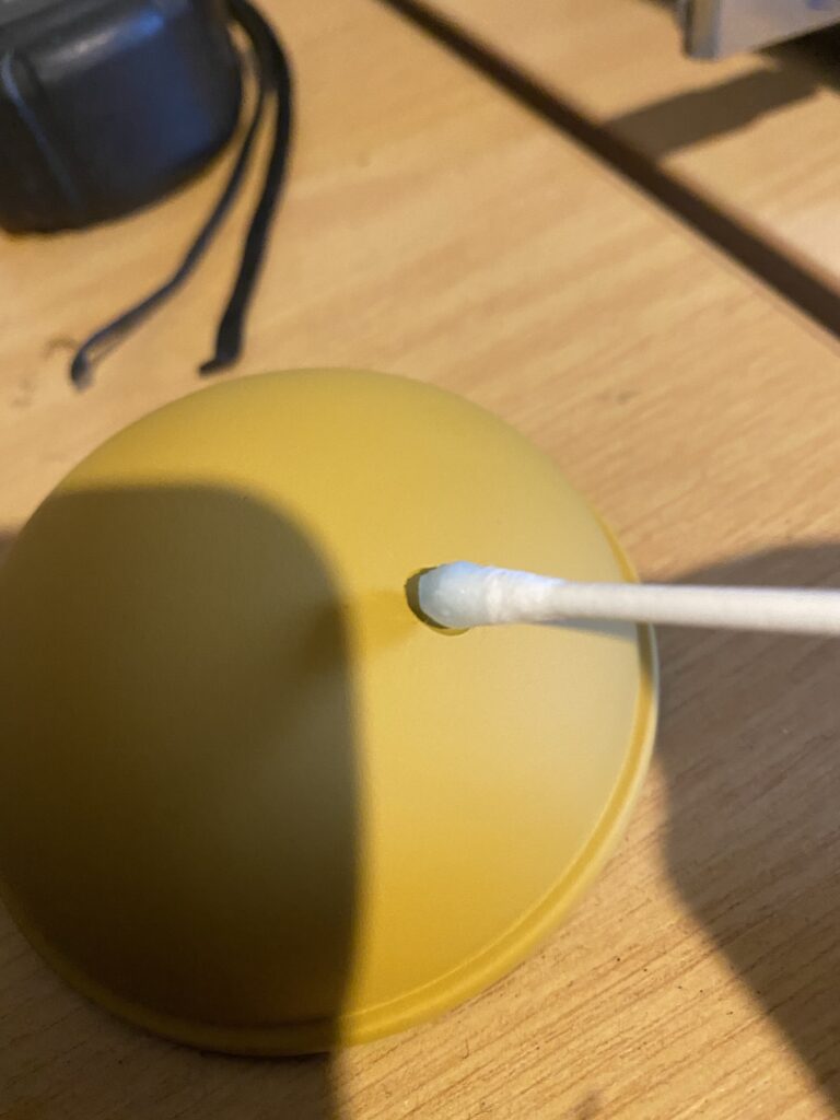 Cotton bud applying resin to dome