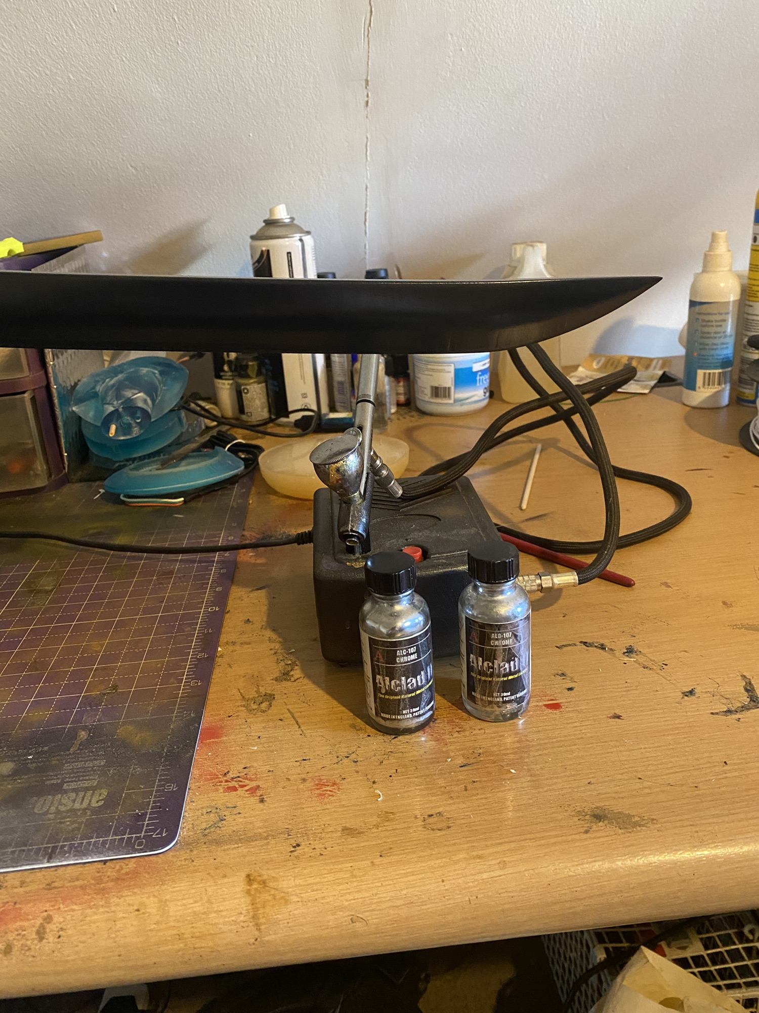 The top of Yones Wind Sword is above two bottles of Alclad Chrome paint and an airbrush.