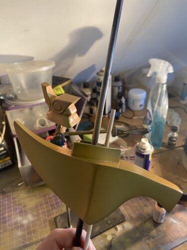 Hilt and pommel after a few coats of gold, in a very messy workspace.