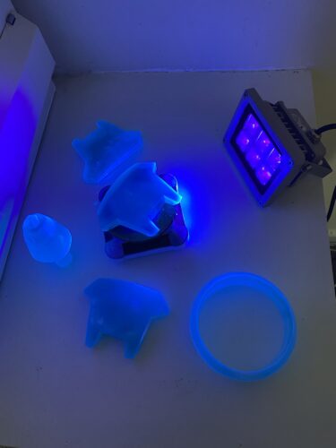 All the SLA parts of the Sym Turret in front of a UV light