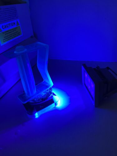 UV Printed handle curing under a blacklight atop a small spinning platform