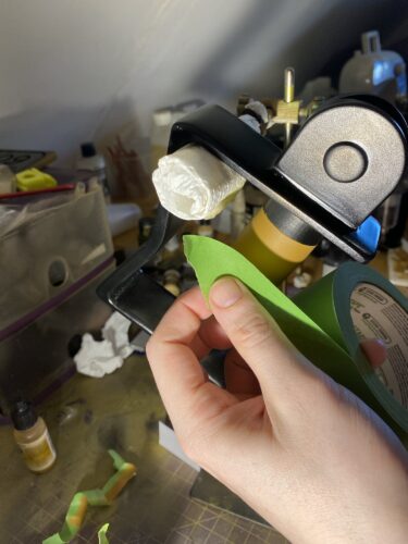 Frog tape being applied to the brown handle part