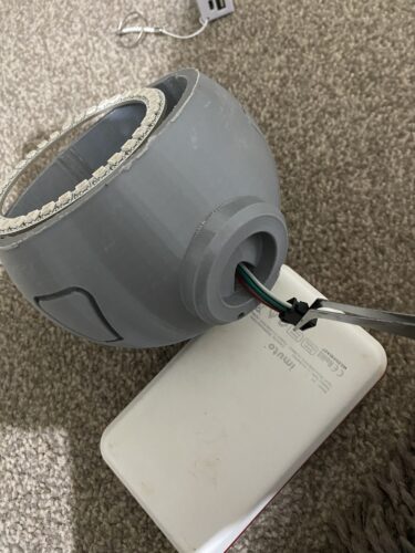 Wiring pulled through the body section of Symmetra's Turret, with a large USB battery next to it.