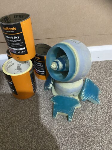 Symmetra's Turret parts loosely assembled, showing signs of having been primed and sanded. In front of rolls of sandpaper.