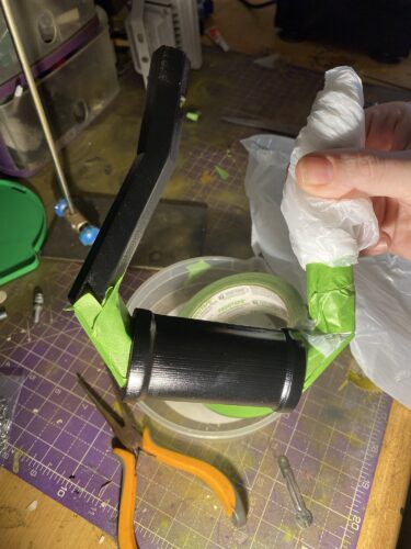 Longshot handle from Zelda having the metal work covered with frog tape in order to work on the gold