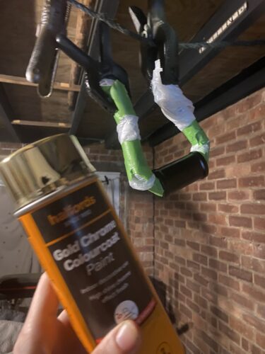 Gold chrome paint can in front of the handle ready for the first colour