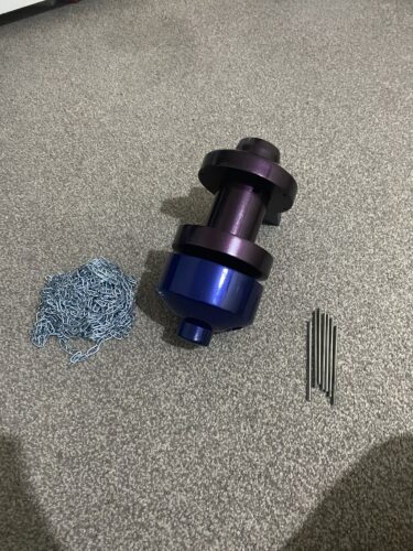 The main body of the zelda OOT longshot prop, coloured and varnished. Next to it is the chain and the metal rods