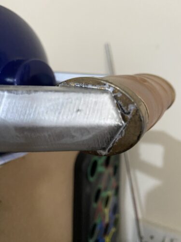 Close up of the handle where the gold meets the silver metal work. Lots of bleeding on the poaintwork and looks bad.