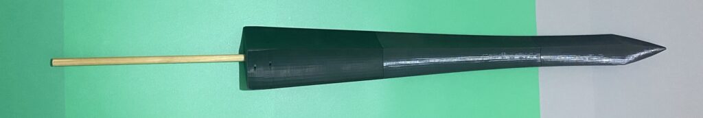 Three parts of the sword affixed to the primary support rod. Green and grey background.