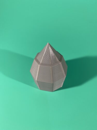 The Pommel, Part of the Raw Build Kit for the Kokiri Sword, printed in grey PLA on a green background.