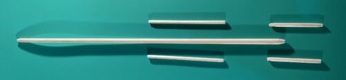A number of wooden dowel intended for support rods ona green background.