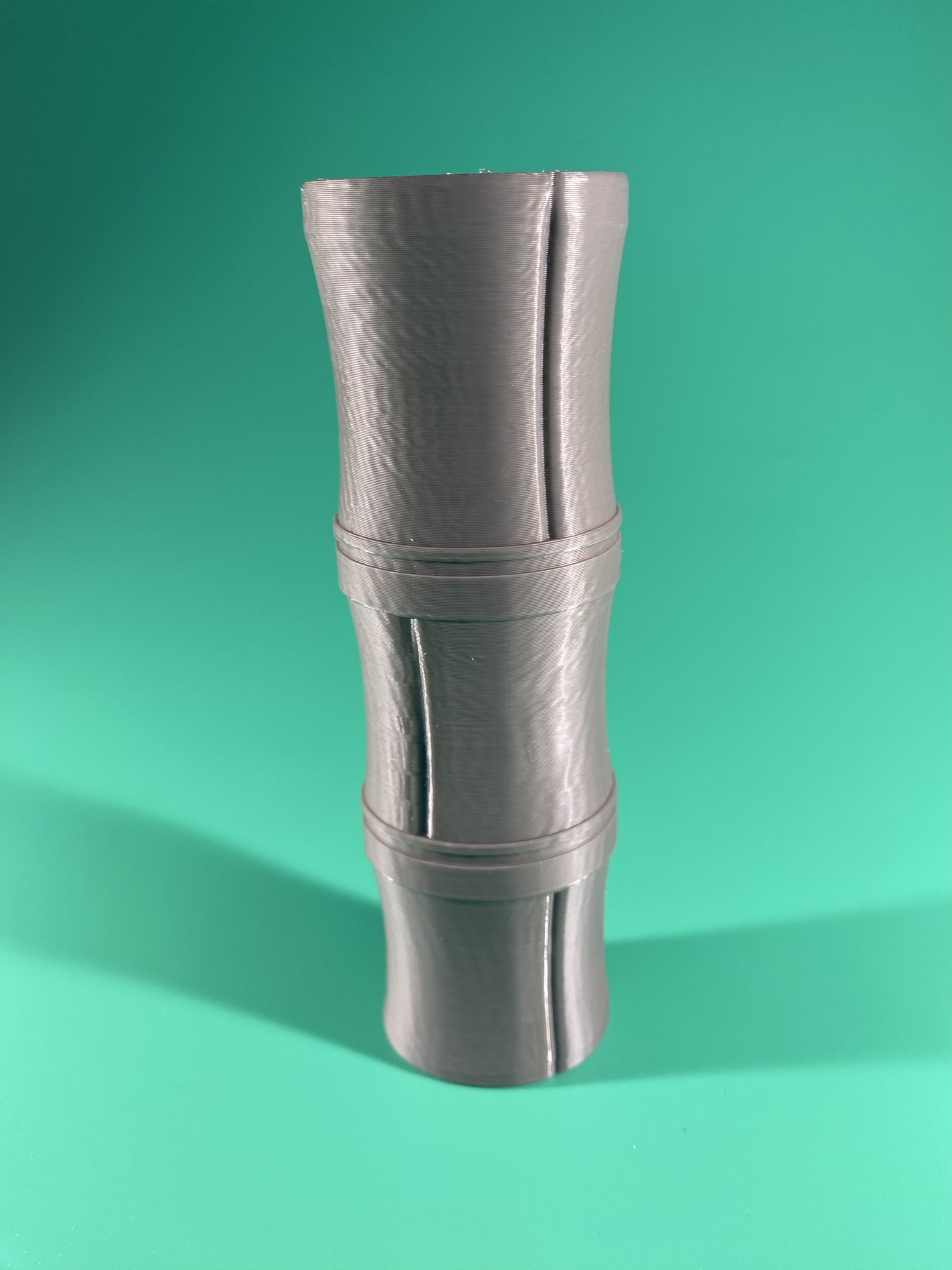 The handle. Part of the Raw Build Kit for the Kokiri Sword from Zelda Majora's Mask, printed in grey PLA on a green background.