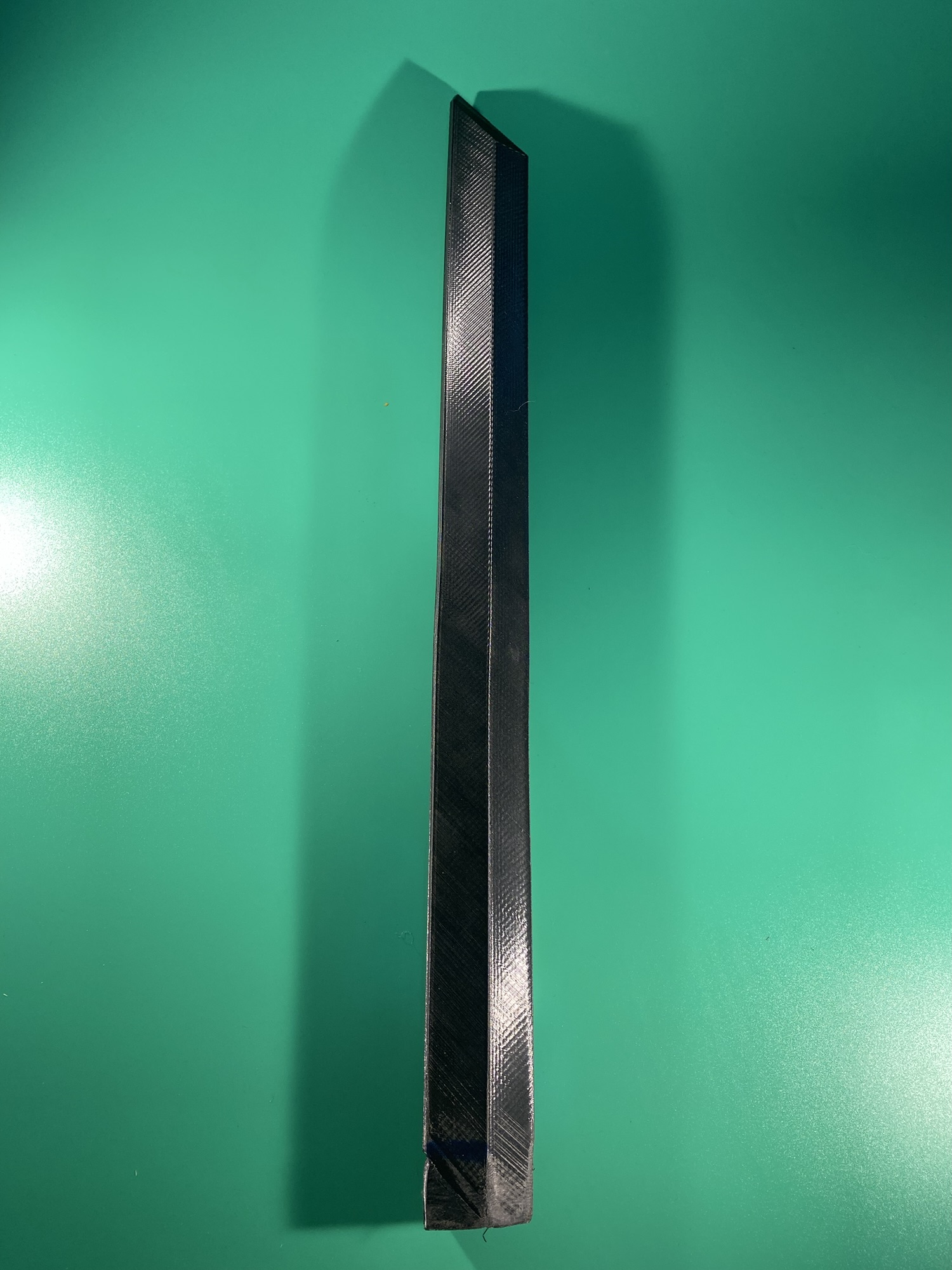 The short blade. Part of the Raw Build Kit for the Razor Sword from Zelda Majora's Mask, printed in black PLA on a green background.