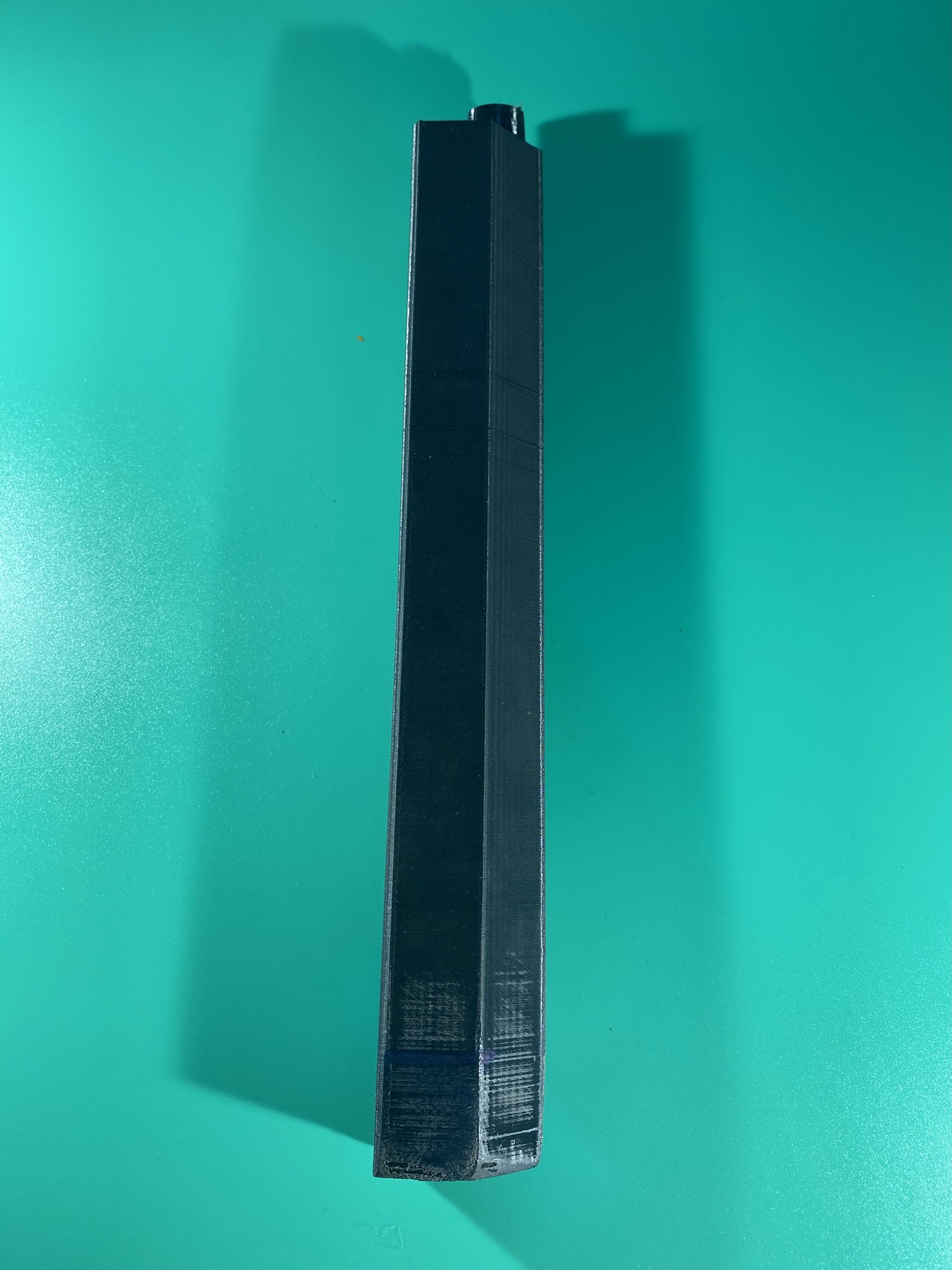 The first part of the long blade. Part of the Raw Build Kit for the Razor Sword from Zelda Majora's Mask, printed in black PLA on a green background.