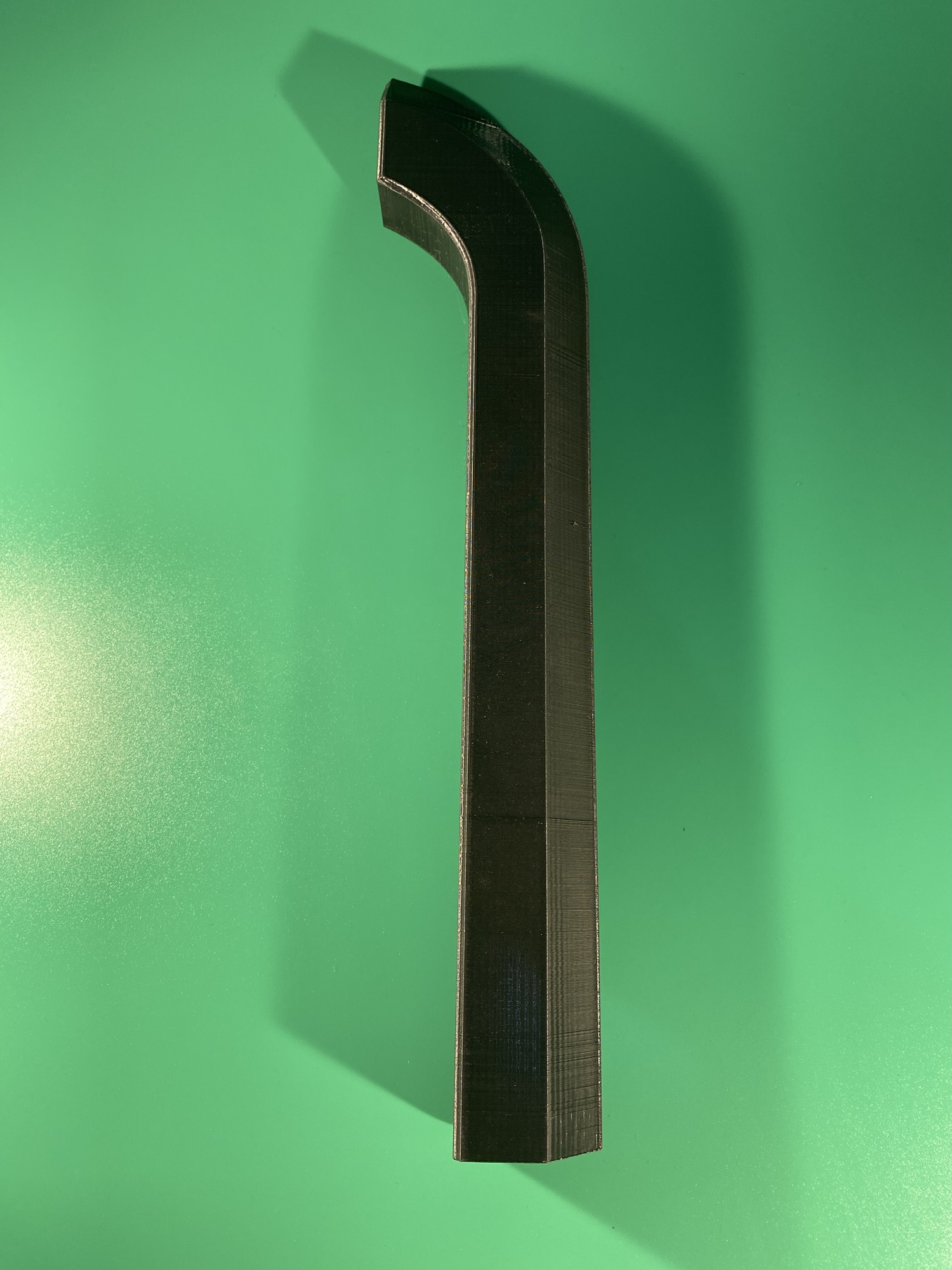 The second part of the long blade. Part of the Raw Build Kit for the Razor Sword from Zelda Majora's Mask, printed in black PLA on a green background.