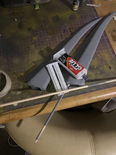 The blade parts of Rikku's Daggers are laid out with some epoxy resin and the support rods.