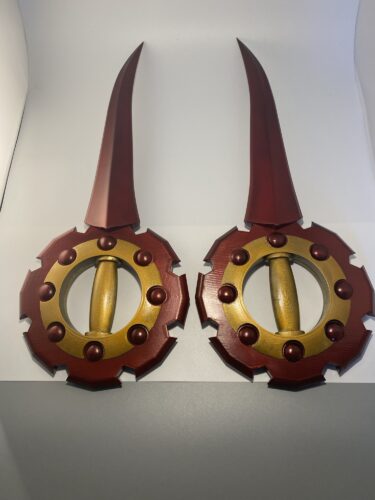 Rikku's Daggers from FFX-2. FInished full build completed on a grey and white background.