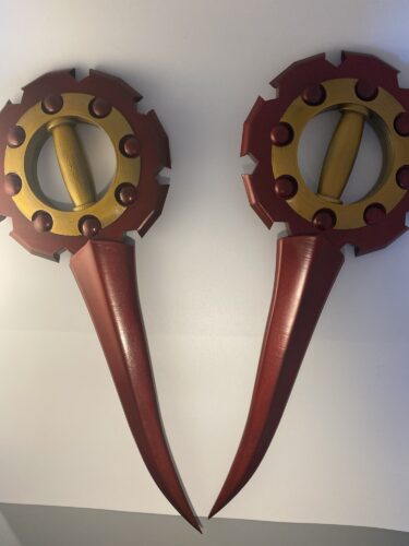 Rikku's Daggers from FFX-2. FInished full build completed on a grey and white background.